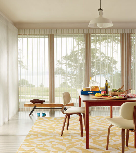 yellow dining room with hunter douglas luminette vertical shades on large windows