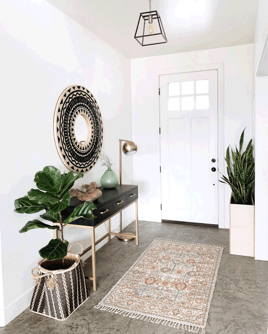 entryway styled with green black and gold modern desert living