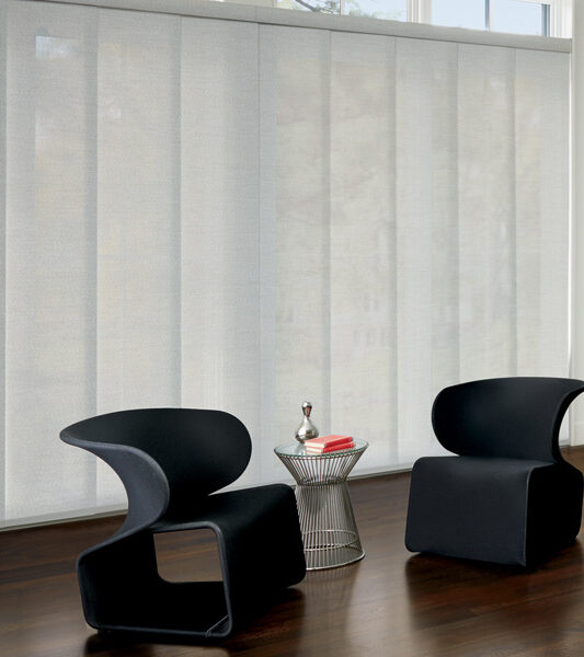 modern minimalistic living room with black chairs and skyline gliding window panels on sliding glass doors by Hunter Douglas Reno
