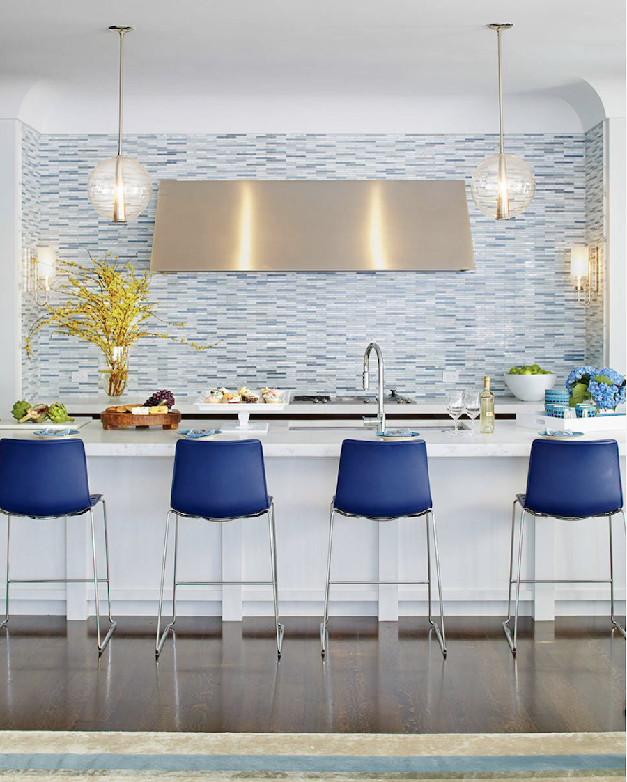 blue backsplash in kitchen with blue accent chairs and florals