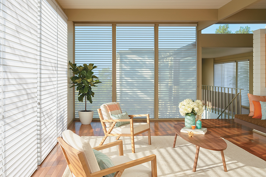 living room with sea foam green and white with natural wood decor large windows nature inspired