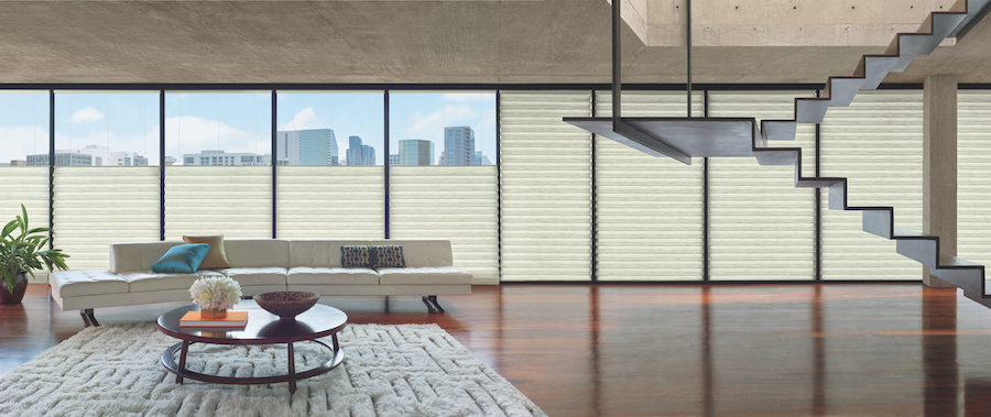 A loft with wall to wall windows with automated shades.