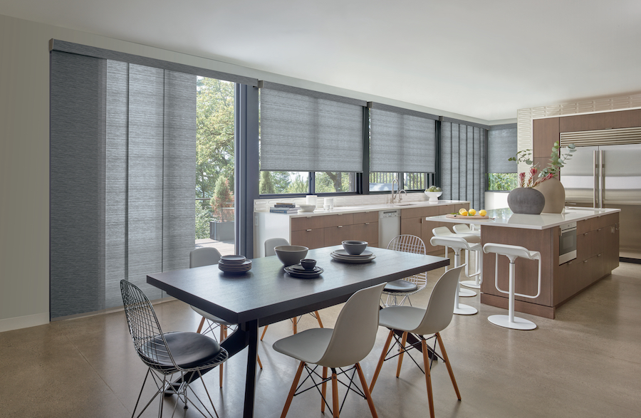 A kitchen with gray designer roller shade fabrics