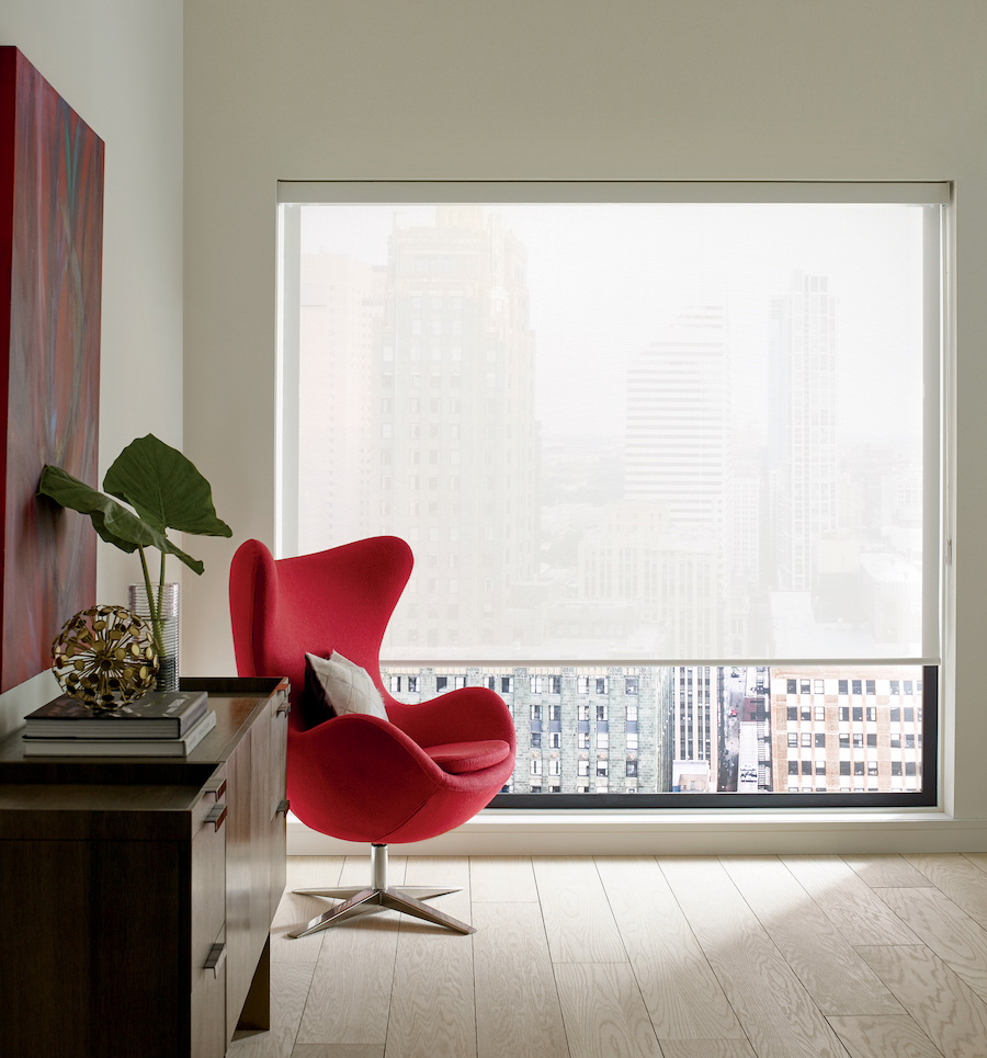 A living room with Designer Screen Roller Shades with 1% Openess Factor