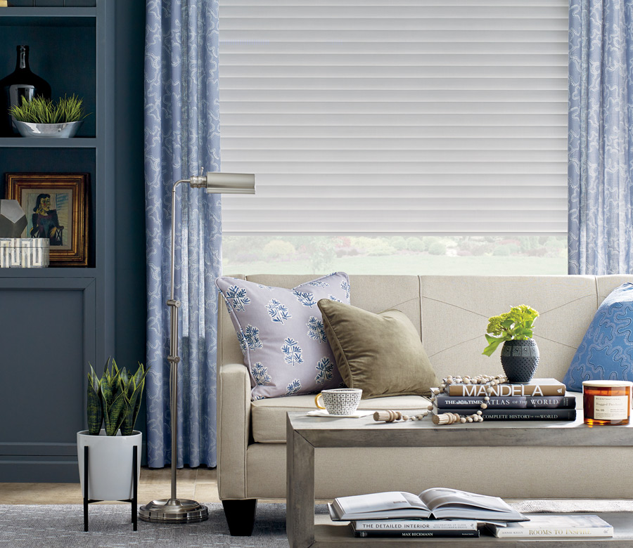 design studio draperies layered with white window shades in living room in Incline Village NV