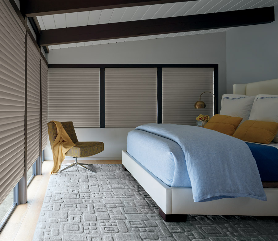 master bedroom with large windows covered with room darkening cellular roller shades in Reno NV
