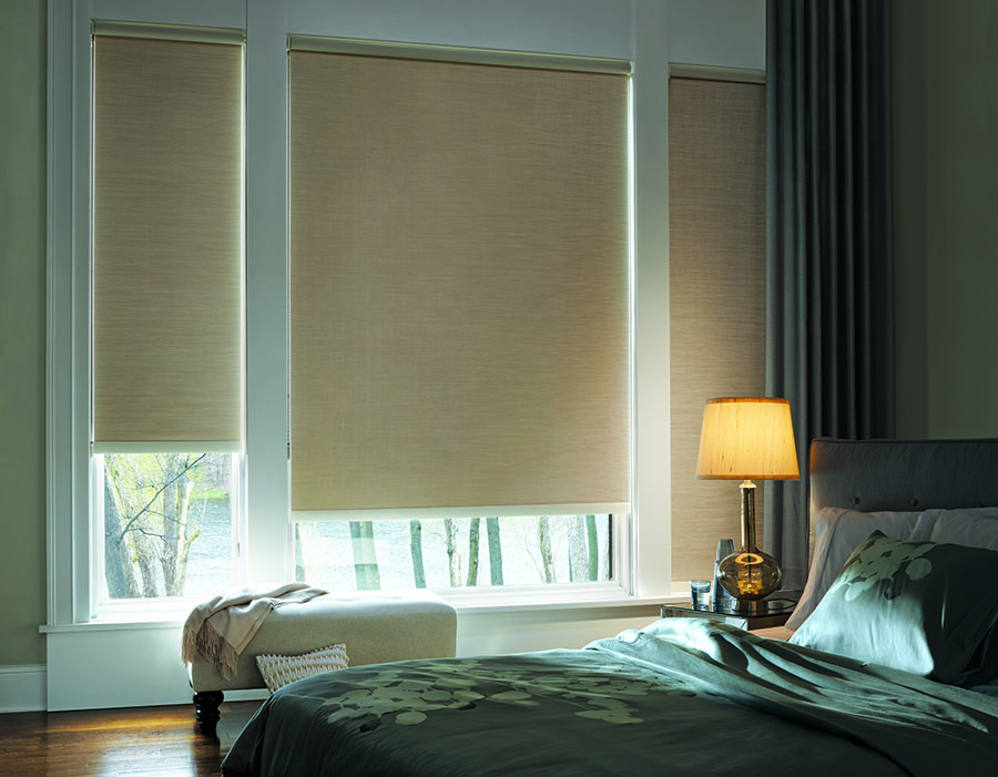 Room darkening roller shades in bedroom.