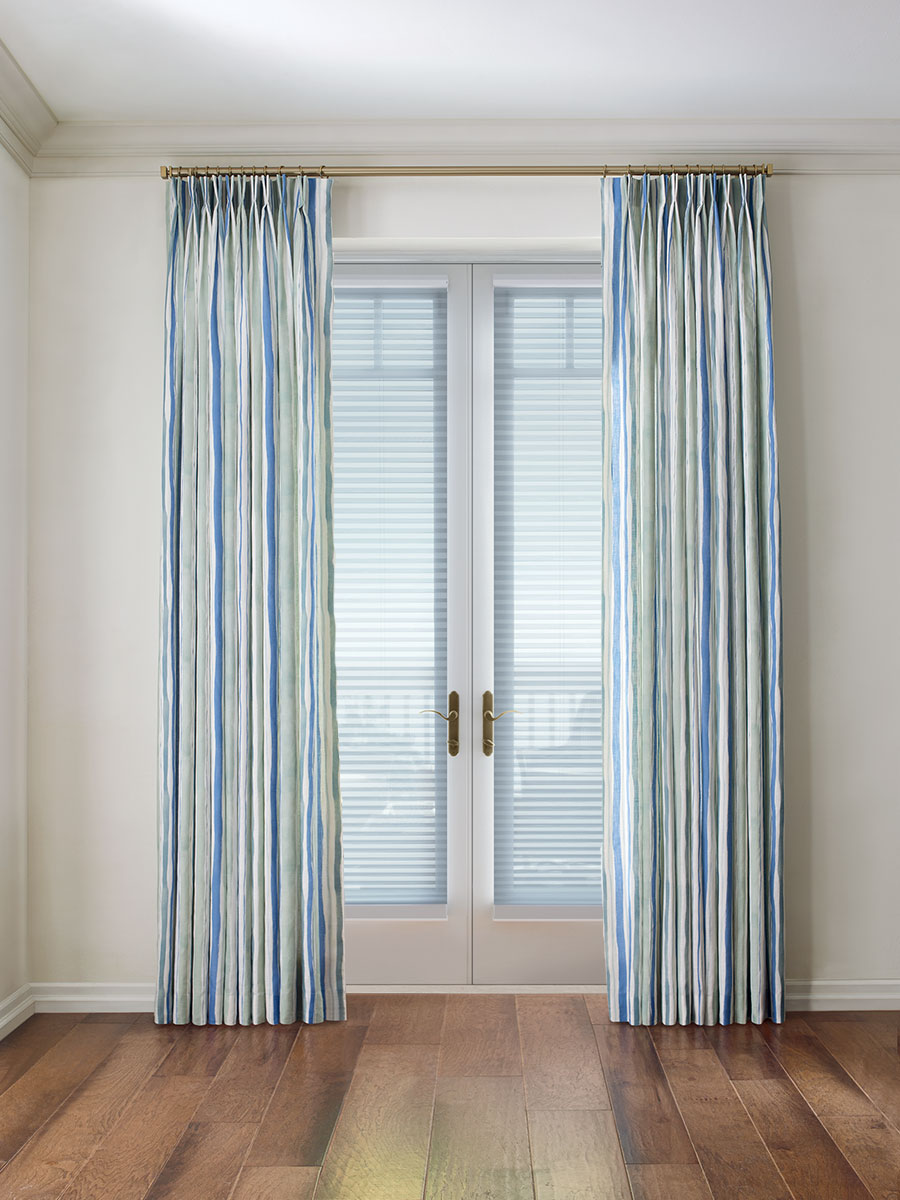 blue draperies over honeycomb shades on french doors in Incline Village NV