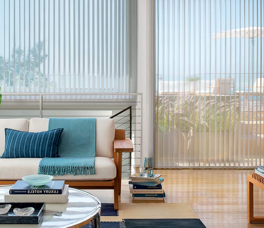 Coastal inspired home with floor to ceiling large window shades from the Luminette Privacy Sheers collection