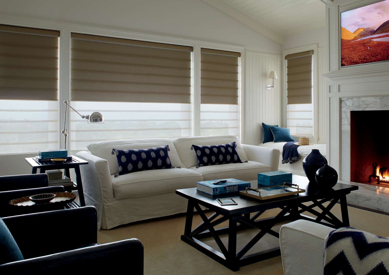 living room with roman shades and blackout roller shades behind in Reno NV