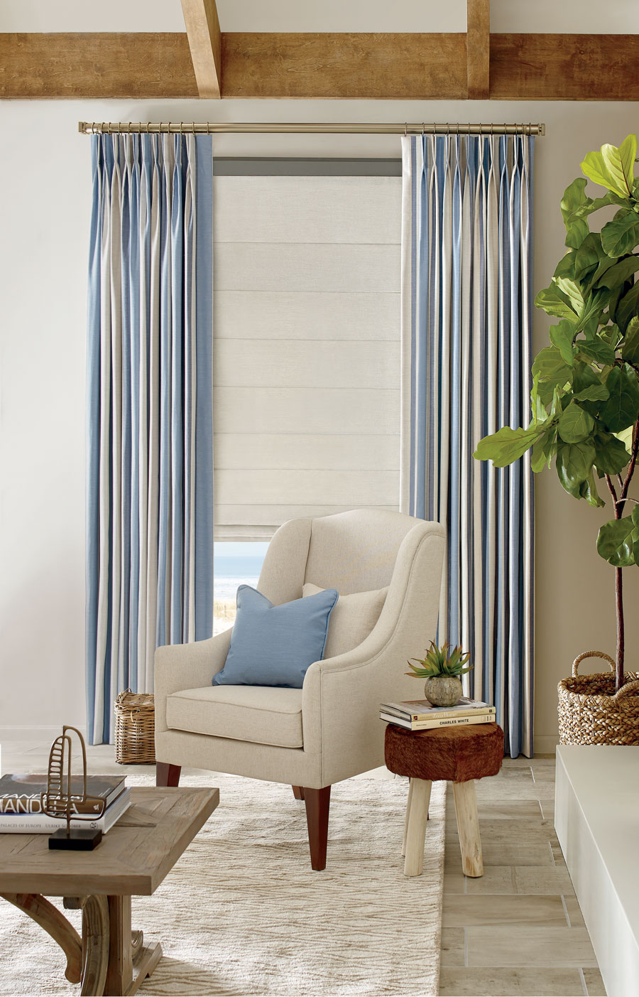 blue striped fabric drapery and coastal inspired white roller shades in Reno, NV