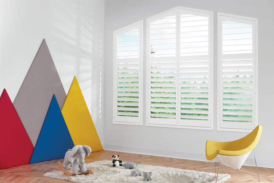 white uniquely shaped angled shutters in childs playroom in Denver CO