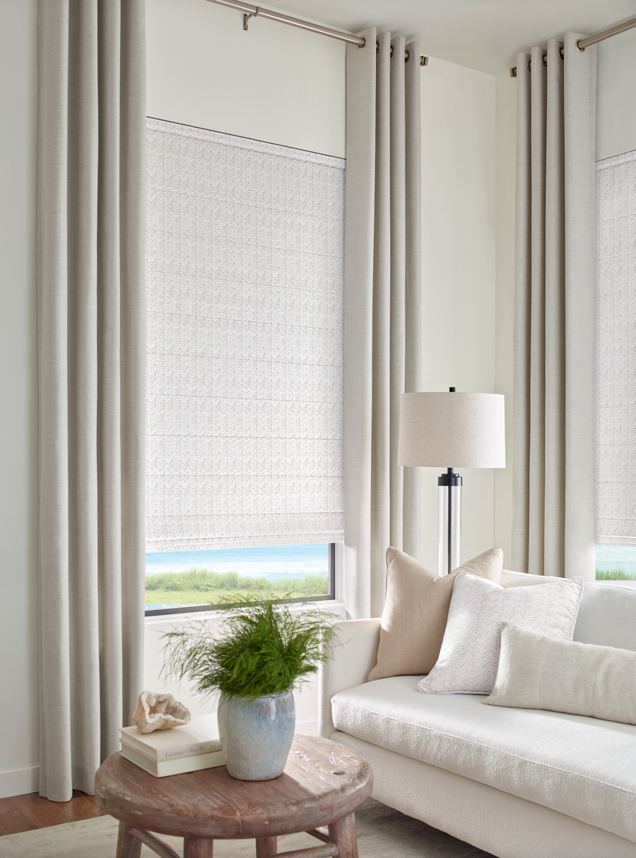 natural colored fabric drapery by seema krish on window overlooking the ocean