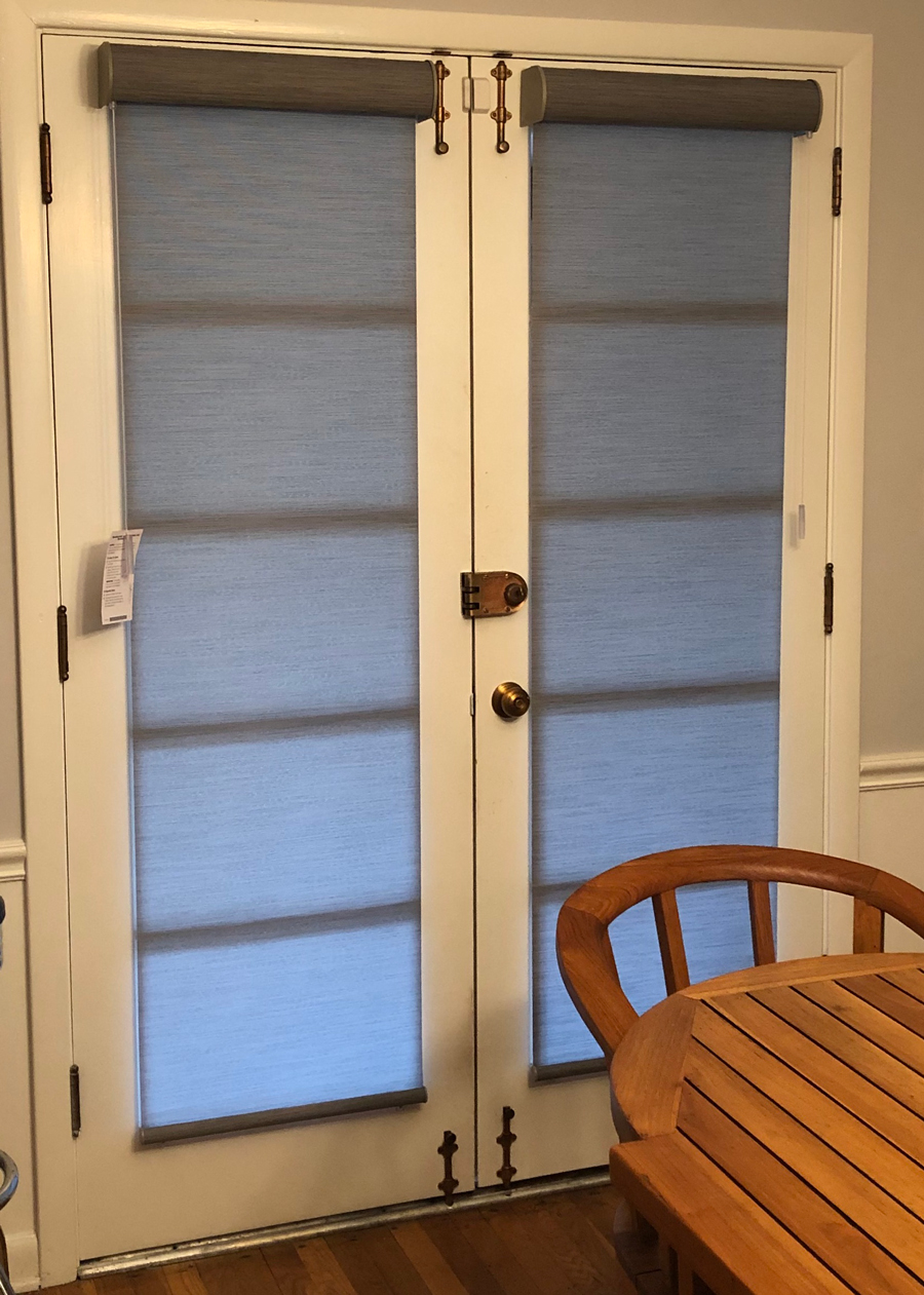 interior french doors of a home with roller shades