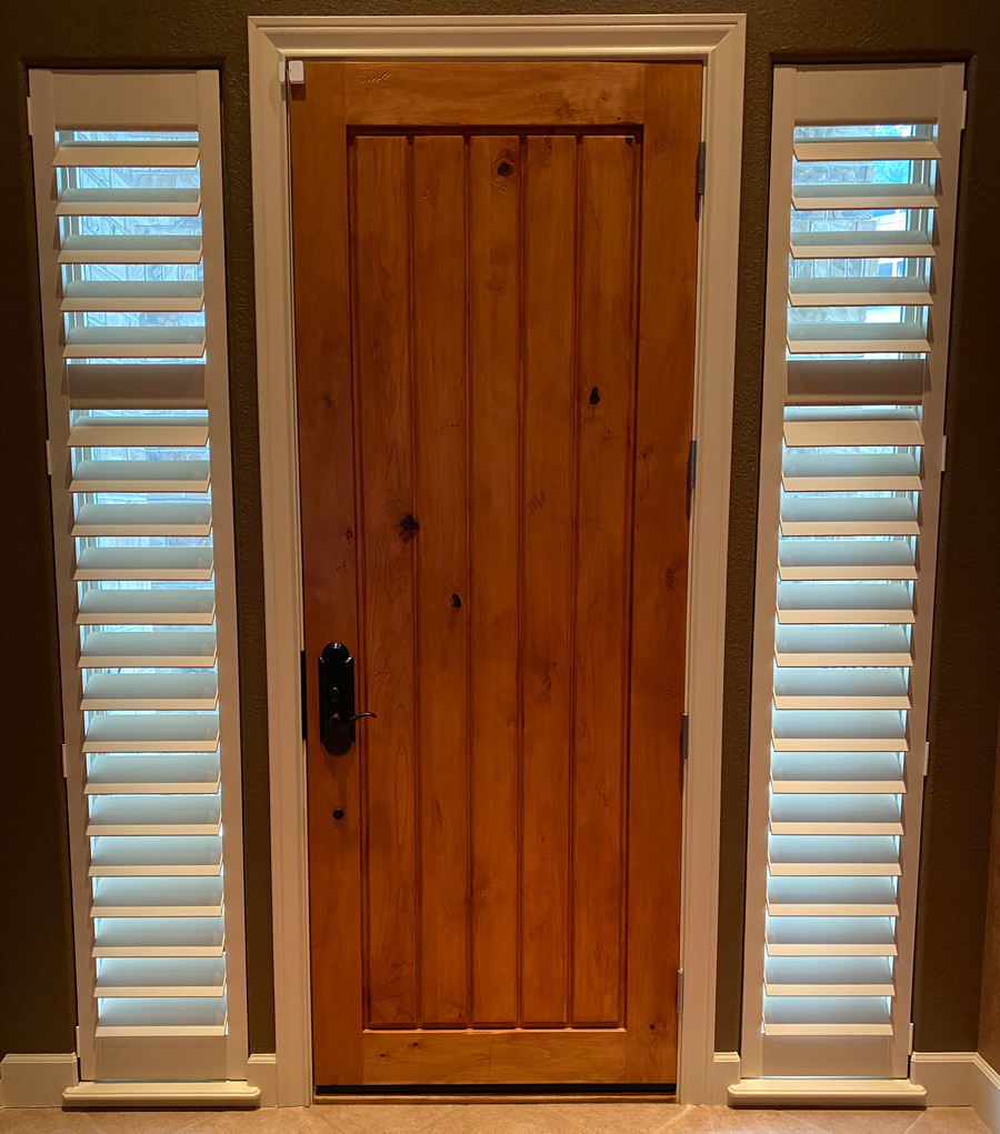 sidelights on entryway doors covered with white shutters