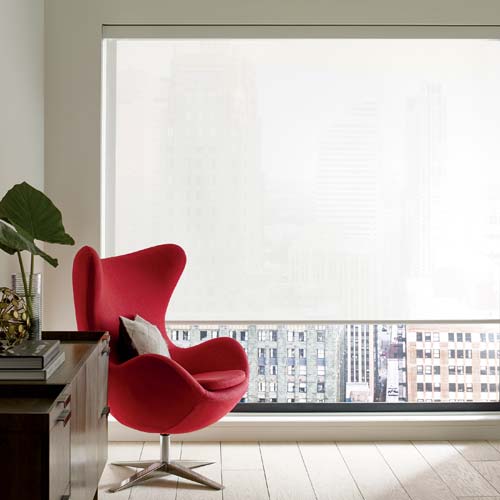 white roller shades with red chair