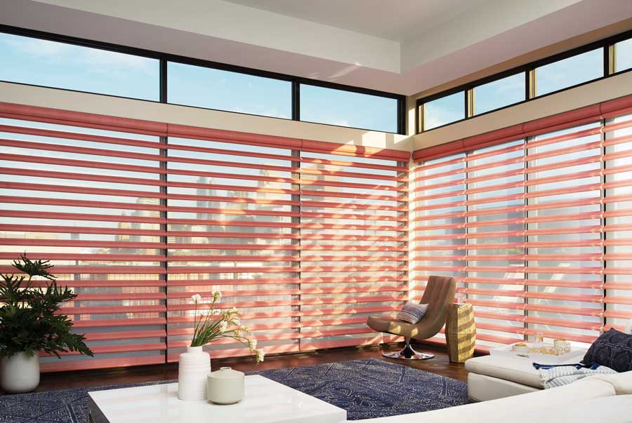 red sheer shades over floor to ceiling windows with black trim