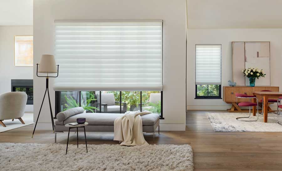 Vignette® Modern Roman Shades in an open floor plan room.