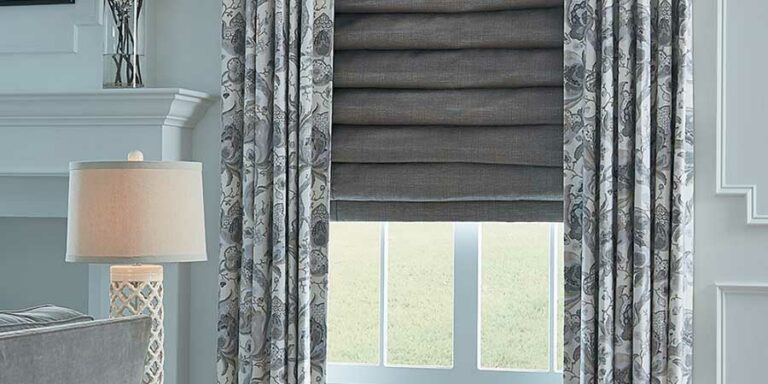 gray roman shades with patterned draperies for layered fabrics in Reno NV living room