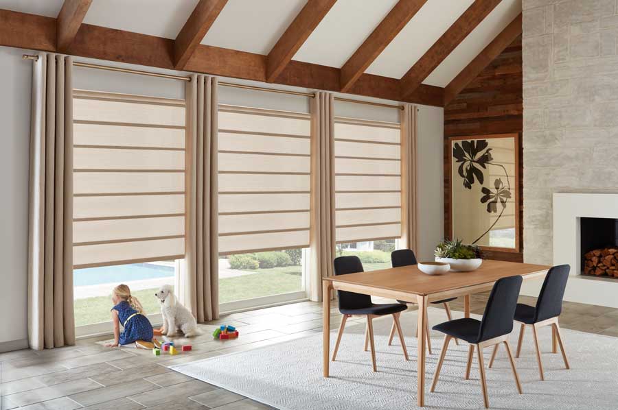 Alustra® Architectural Roller Shades rolled down three/fourths. Child and dog staring out to the backyard.