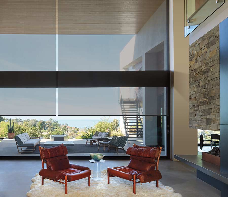 opaque roller shades on large window facing outdoor patio space with chairs