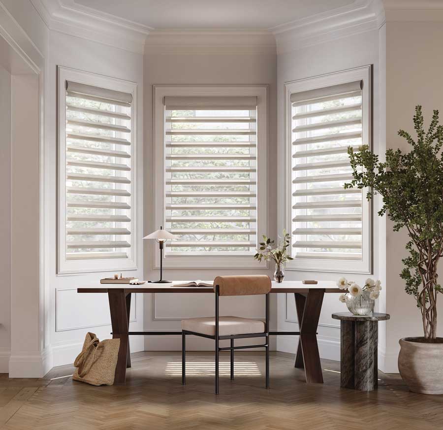 pirouette shades on bay windows in home office nook
