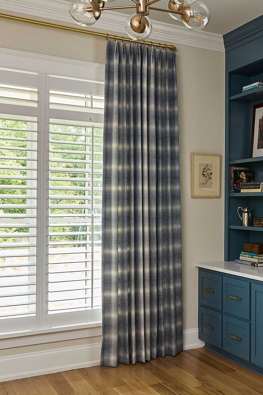 blue and white checkered plaid drapery at window with white blinds