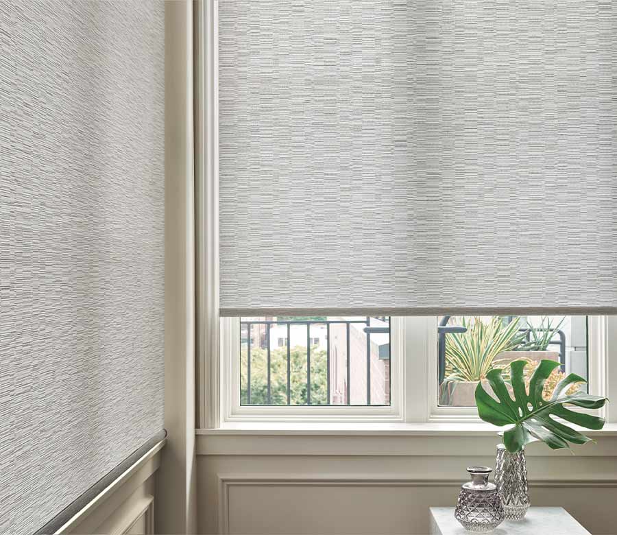 white designer roller shades in corner windows