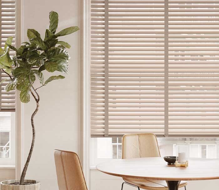dining room with gold metal blinds