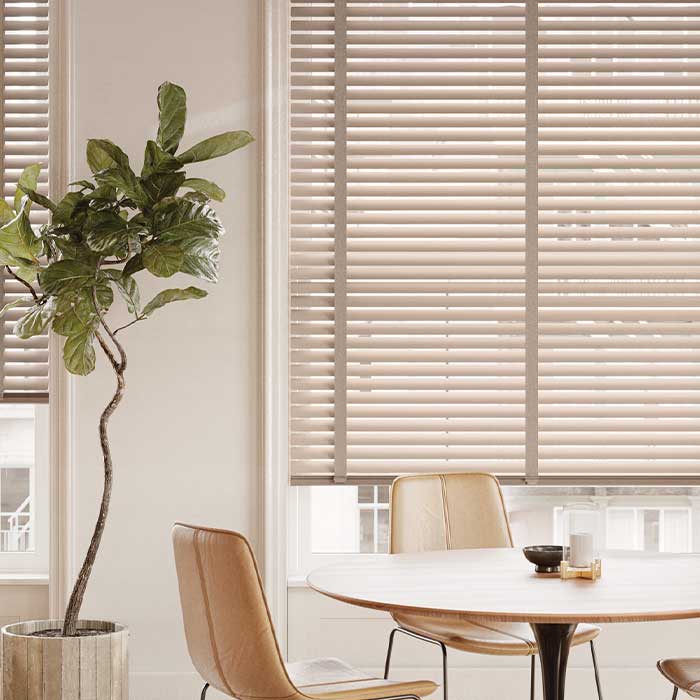 dining room with gold metal blinds