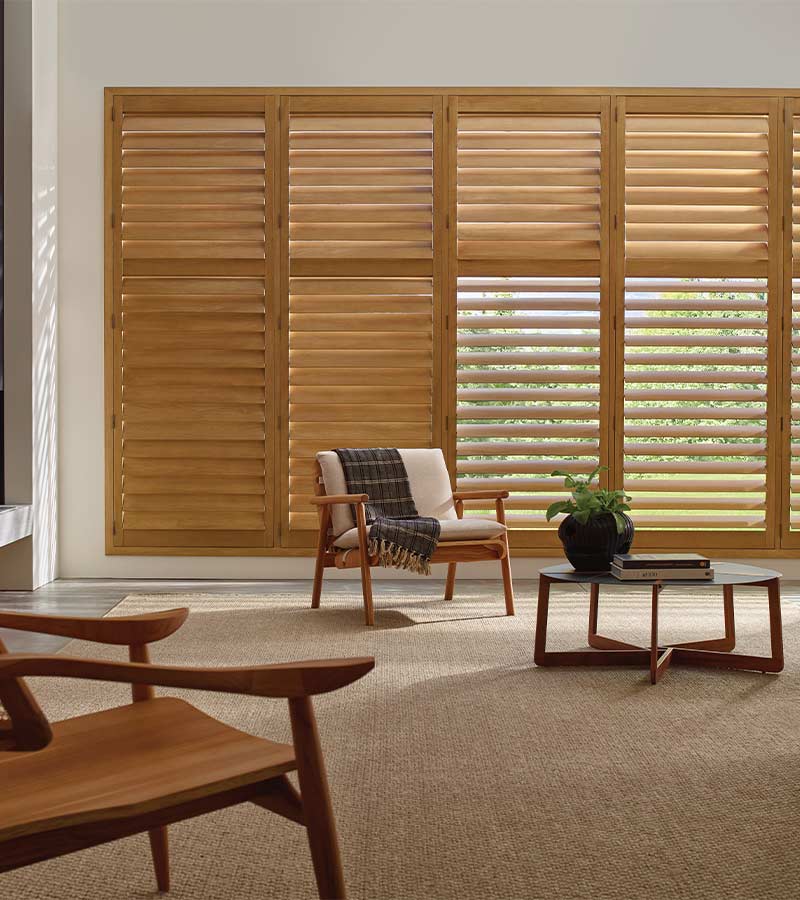 energy-efficient-heritance-hardwood-shutters-window-treatments-blue-sky-shutters-and-shades wood shutters for large window in living room energy efficient