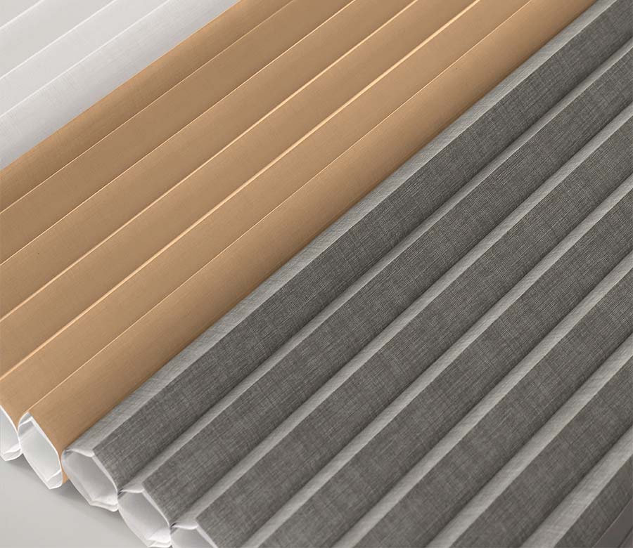 detail of different fabrics for a double cell shade in tan, gray, and white in Reno, NV home