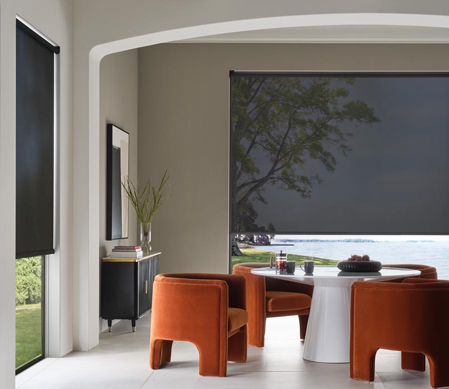 large black screen shades in dining room with orange chairs