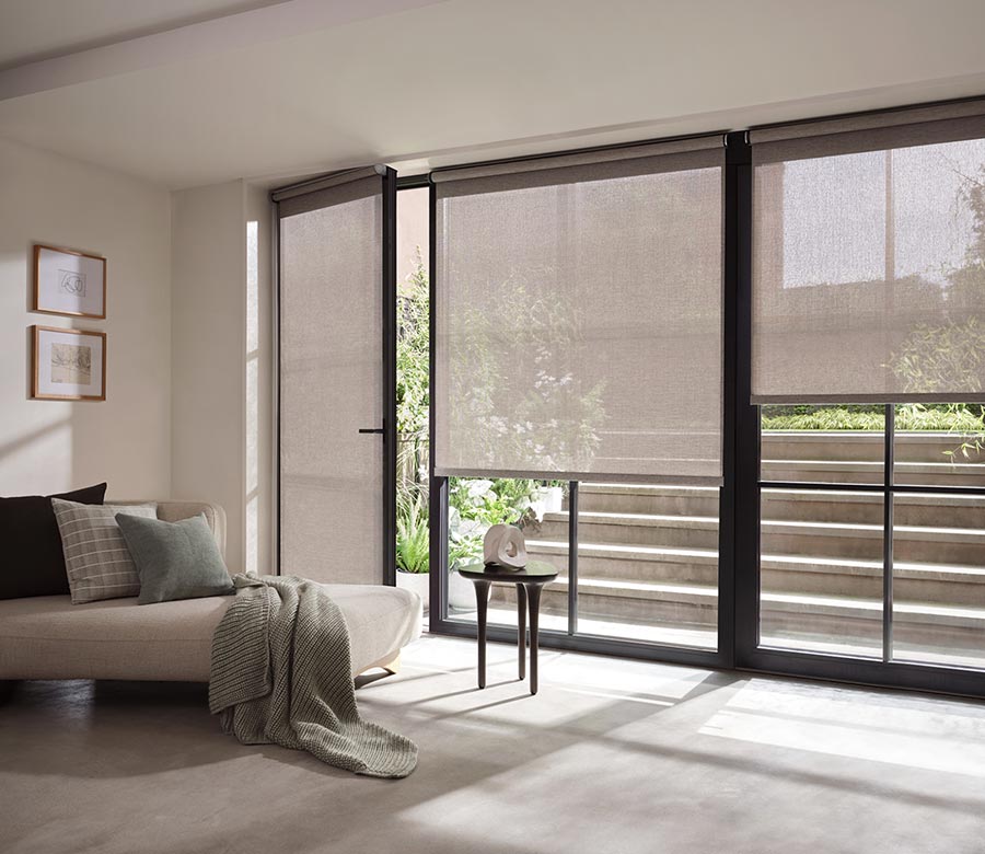 gray designer screen shades on glass doors leading to outside stairs